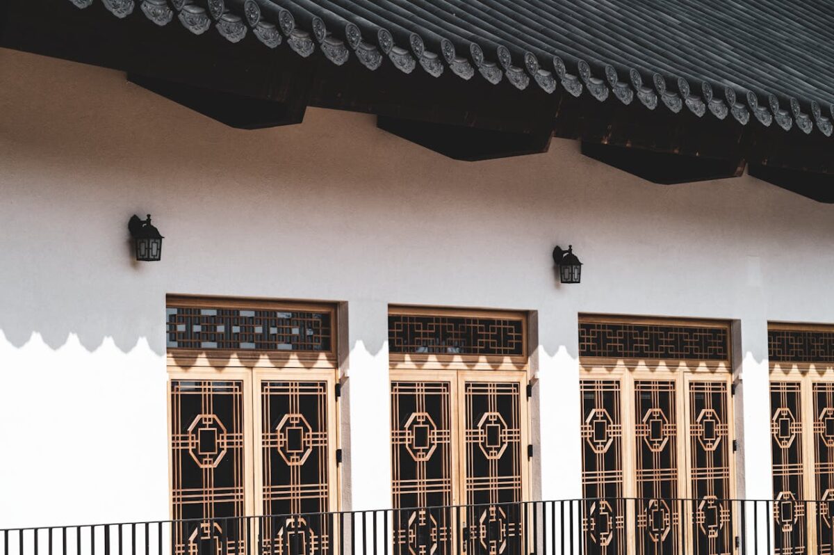 Elegant traditional Asian architecture with wooden lattice doors and shadow play.